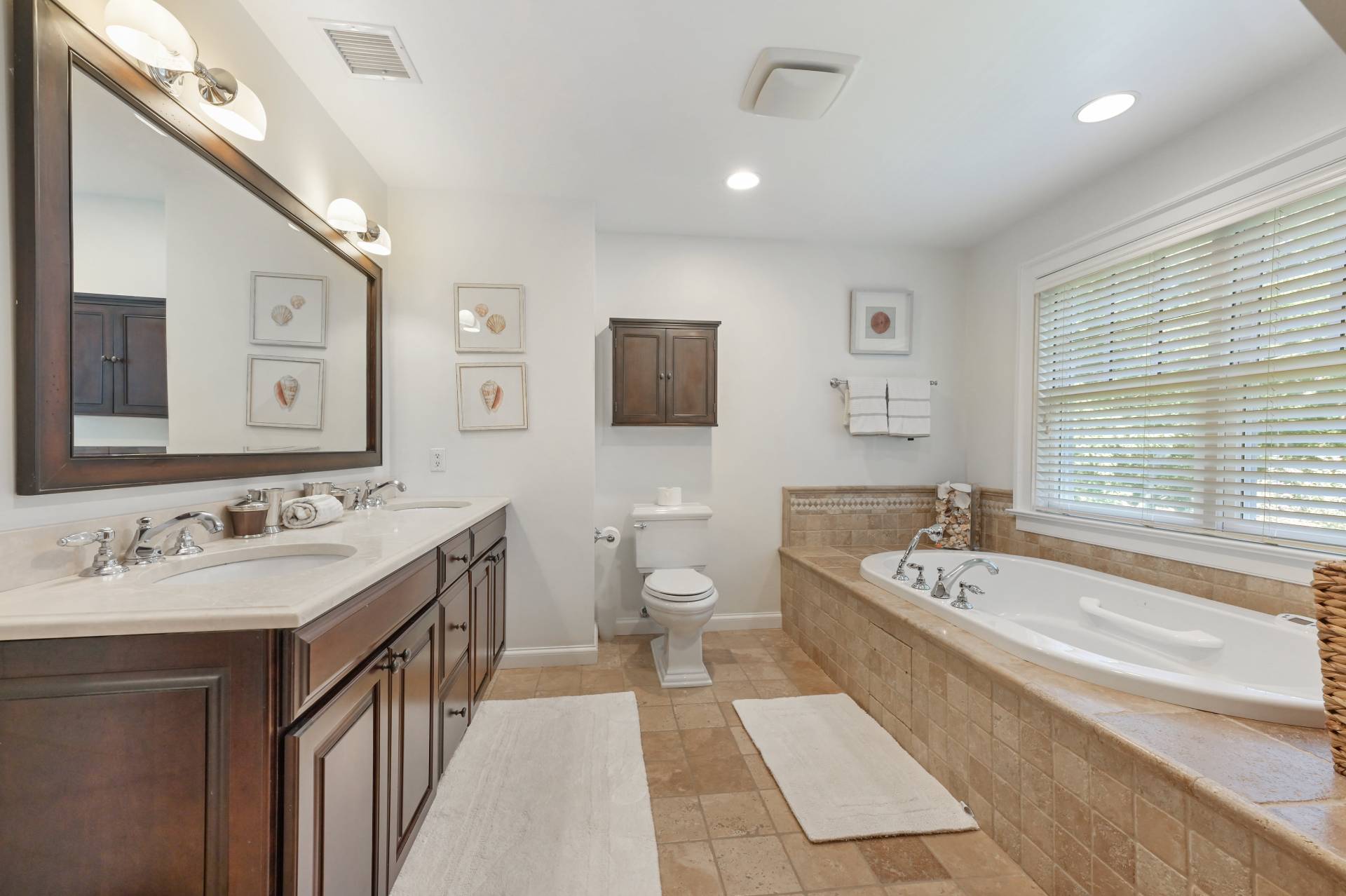 Undisclosed Address Water Mill, NY 11976 - Photo 20 of 28 a spacious bathroom with a double vanity sink mirror and a bathtub