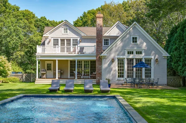 a front view of a house with a yard table and chairs