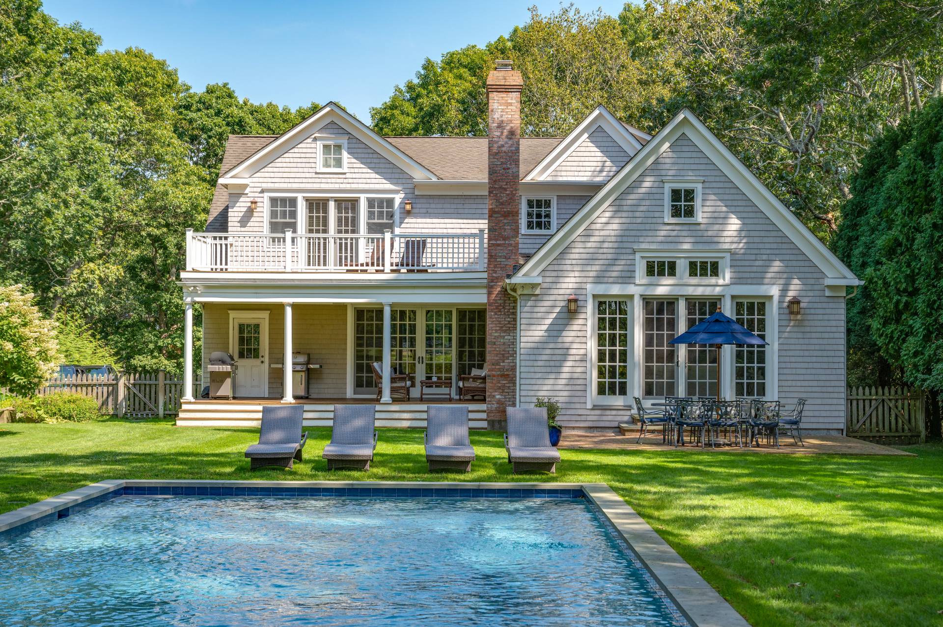 Undisclosed Address Water Mill, NY 11976 - Photo 4 of 28 a front view of a house with a yard table and chairs