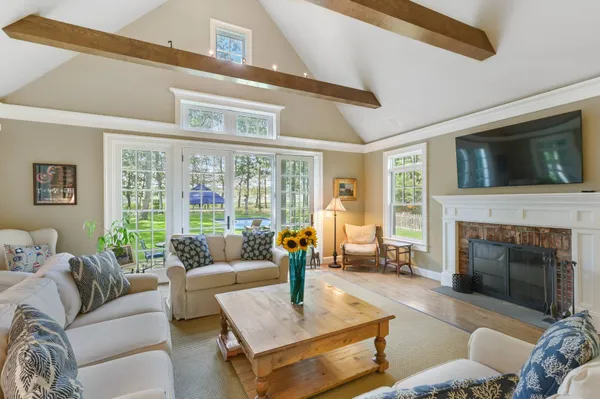 a living room with furniture fireplace and a flat screen tv