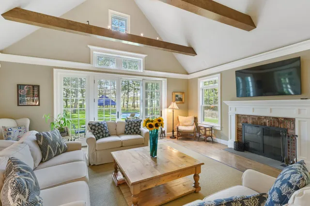 a living room with furniture fireplace and a flat screen tv