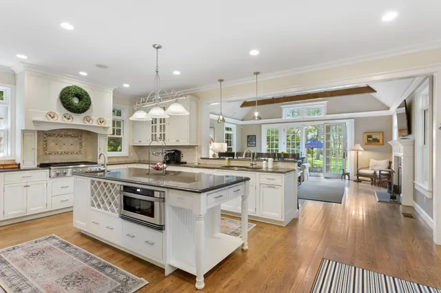 a kitchen with a stove oven and a view of living room