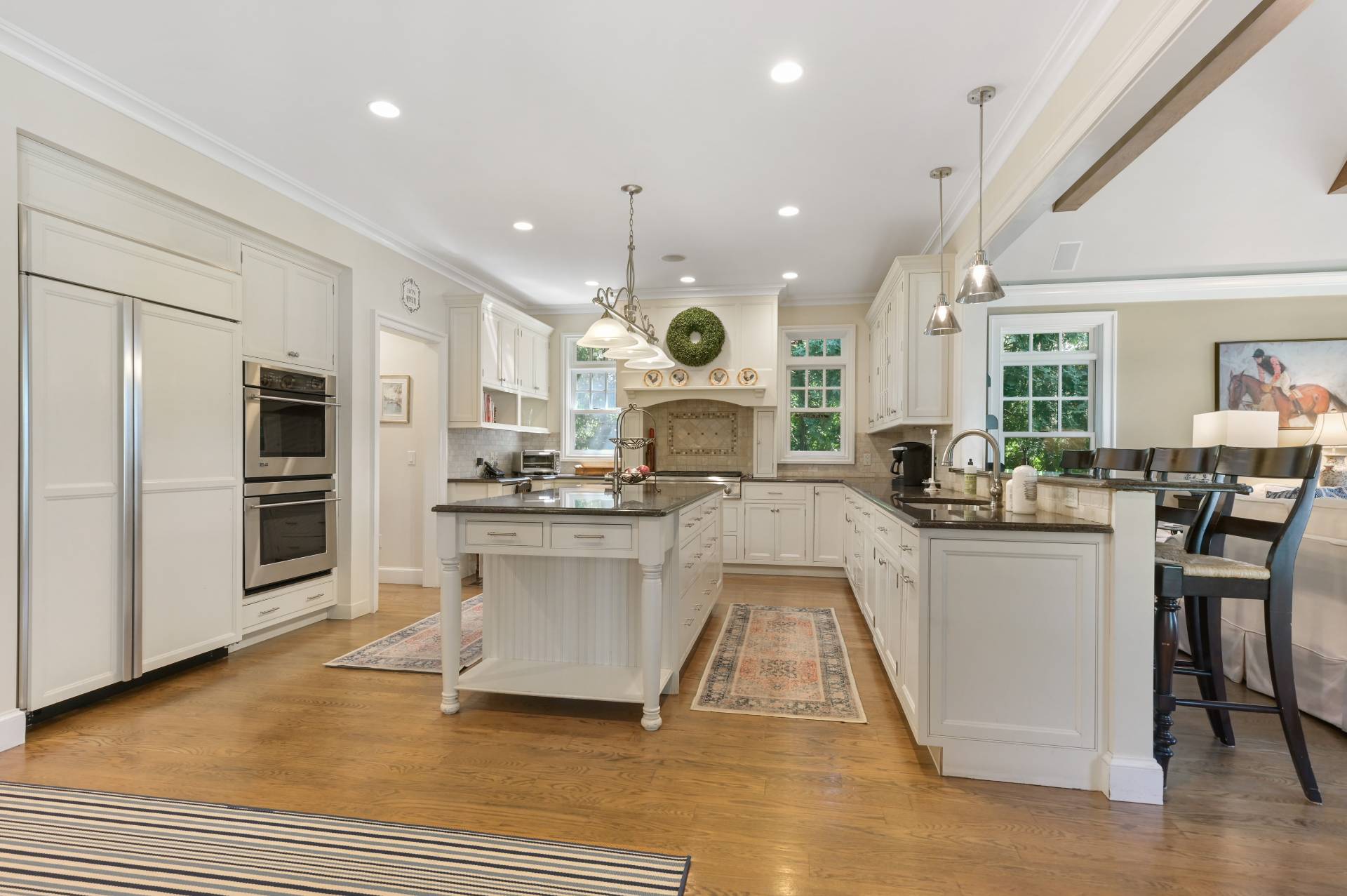 Undisclosed Address Water Mill, NY 11976 - Photo 9 of 28 a large kitchen with kitchen island a large counter top space a sink stainless steel appliances and cabinets