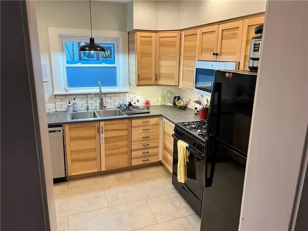 a kitchen with stainless steel appliances granite countertop a refrigerator and a sink