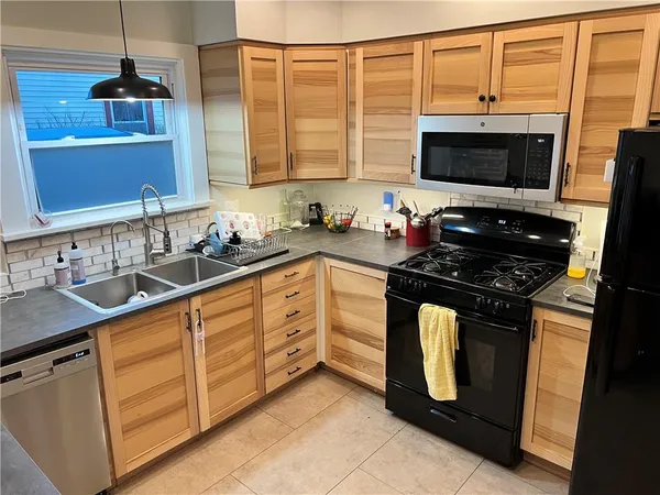 a kitchen with stainless steel appliances a stove sink and microwave