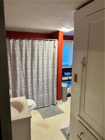 a bathroom with a toilet and a shower