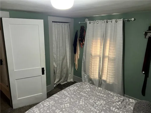 a bedroom with bed and a window