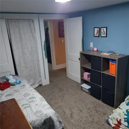 a bedroom with a bed and a television