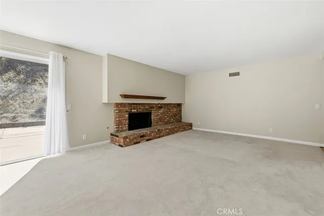 a view of empty room with fireplace