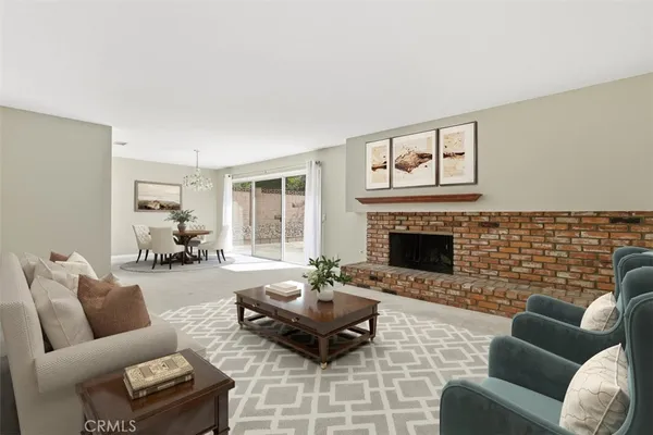 a living room with furniture wooden floor and a fireplace