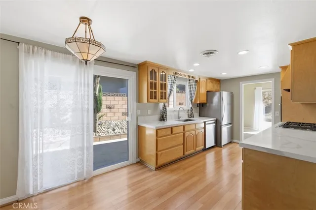 a kitchen with stainless steel appliances granite countertop a stove and refrigerator