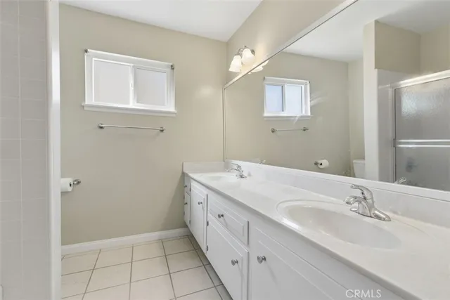 a bathroom with a double vanity sink and a mirror