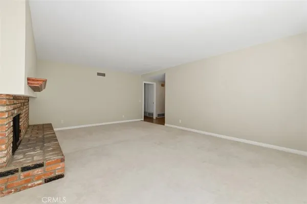 a view of an empty room and wooden floor