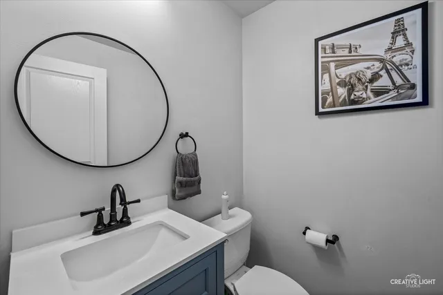 a bathroom with a toilet a sink and a mirror