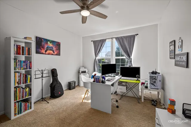 a view of a livingroom with workspace and a window