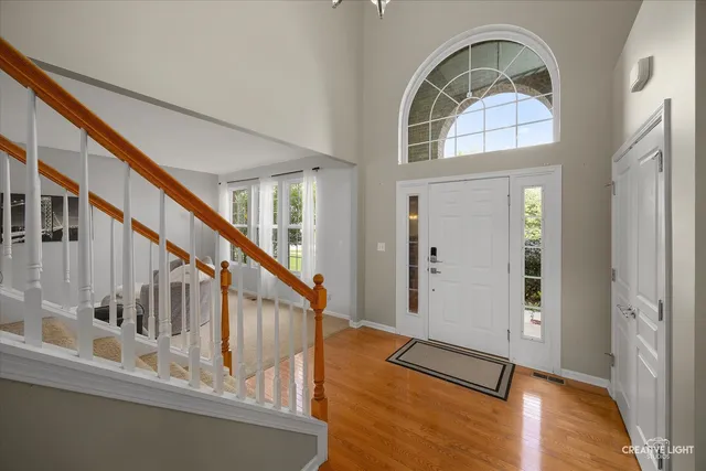 a view of staircase with wooden floor and a large window