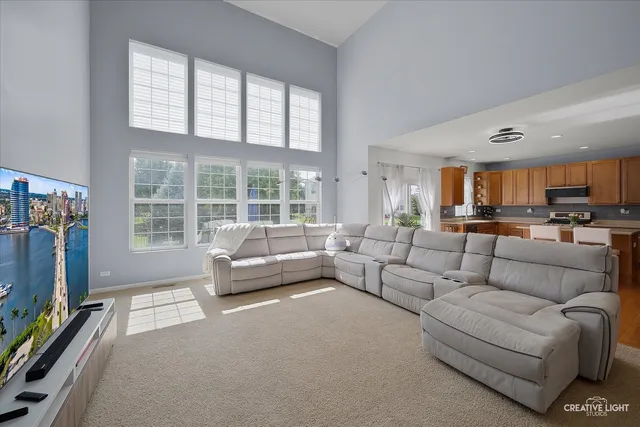 a living room with furniture a flat screen tv and a window