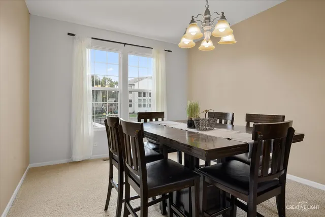 a view of a dining room with furniture and window