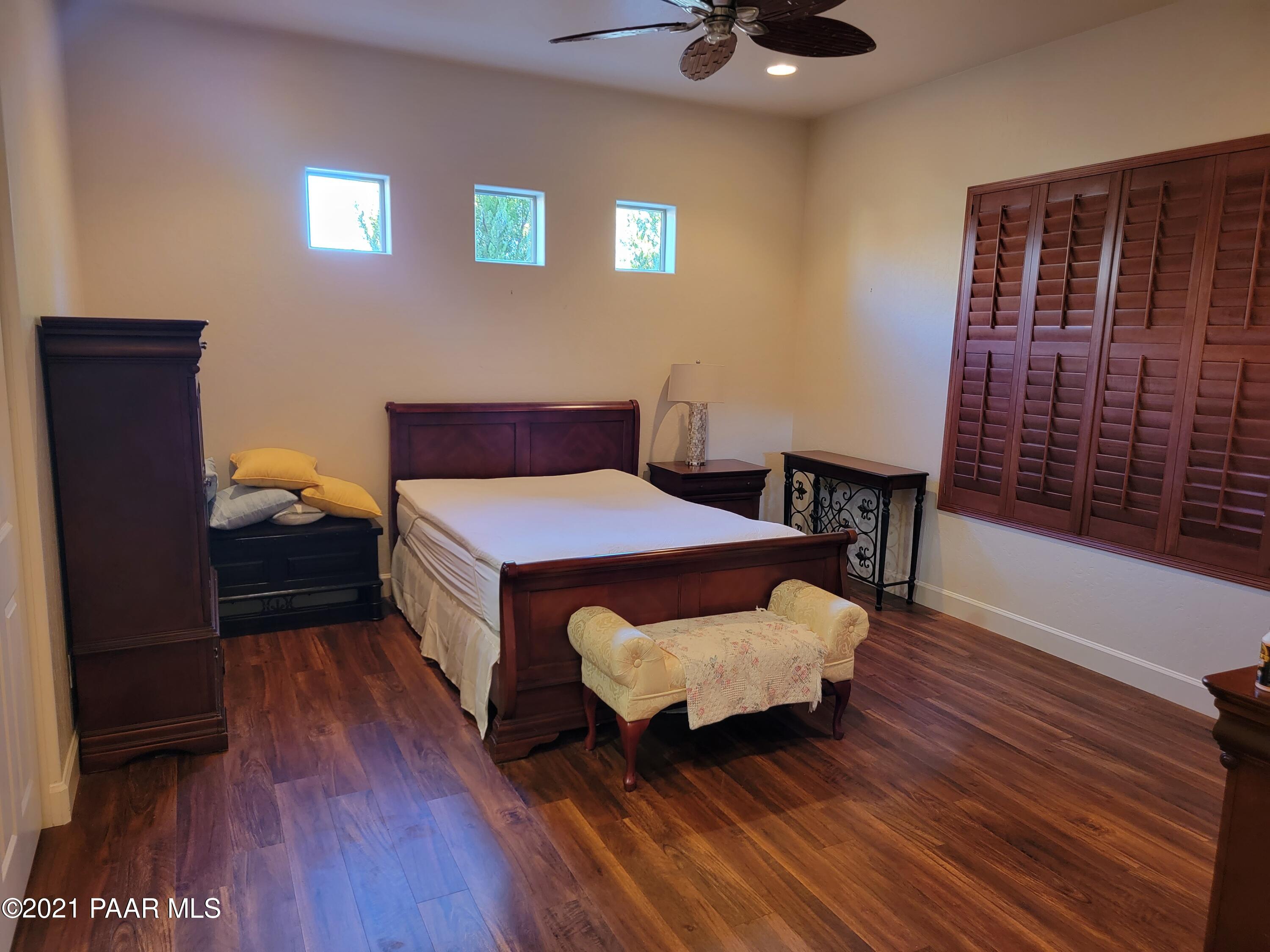 1181 Stack Rock Road Prescott Valley, AZ 86314 - Photo 14 of 25 a bedroom with a bed and wooden floor