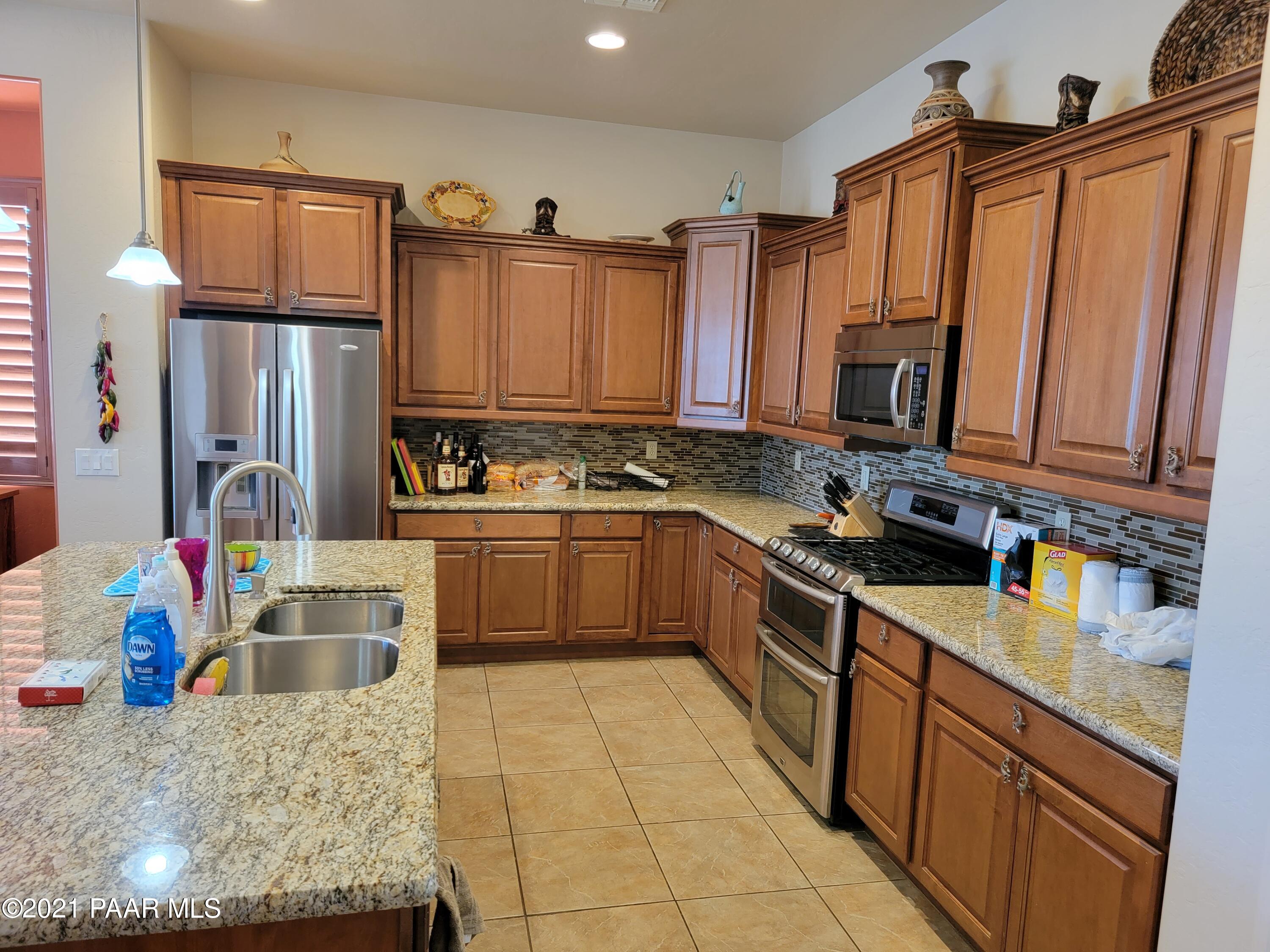 1181 Stack Rock Road Prescott Valley, AZ 86314 - Photo 7 of 25 a kitchen with stainless steel appliances granite countertop a sink stove and refrigerator
