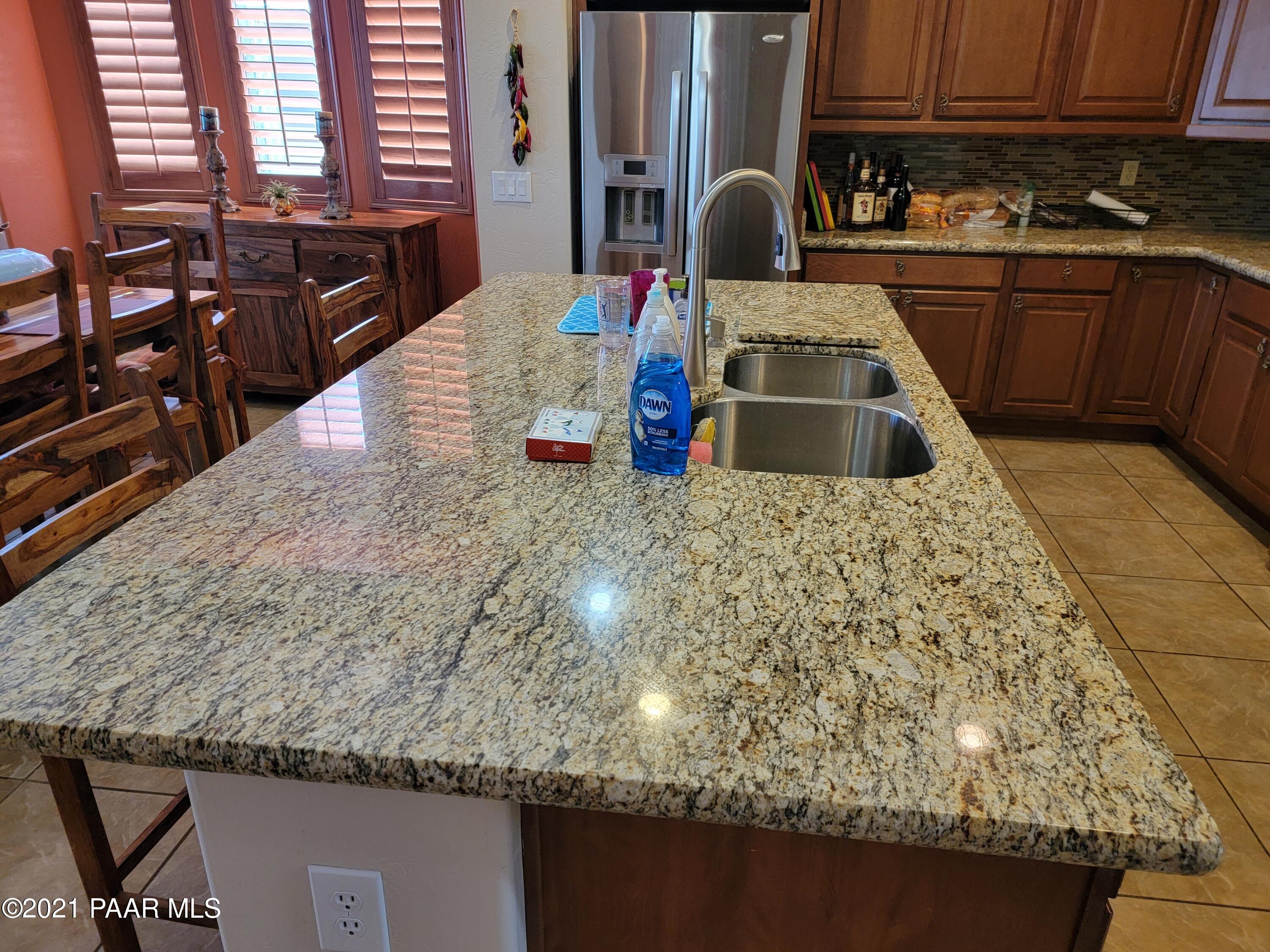 1181 Stack Rock Road Prescott Valley, AZ 86314 - Photo 8 of 25 a kitchen with kitchen island granite countertop a sink and stove