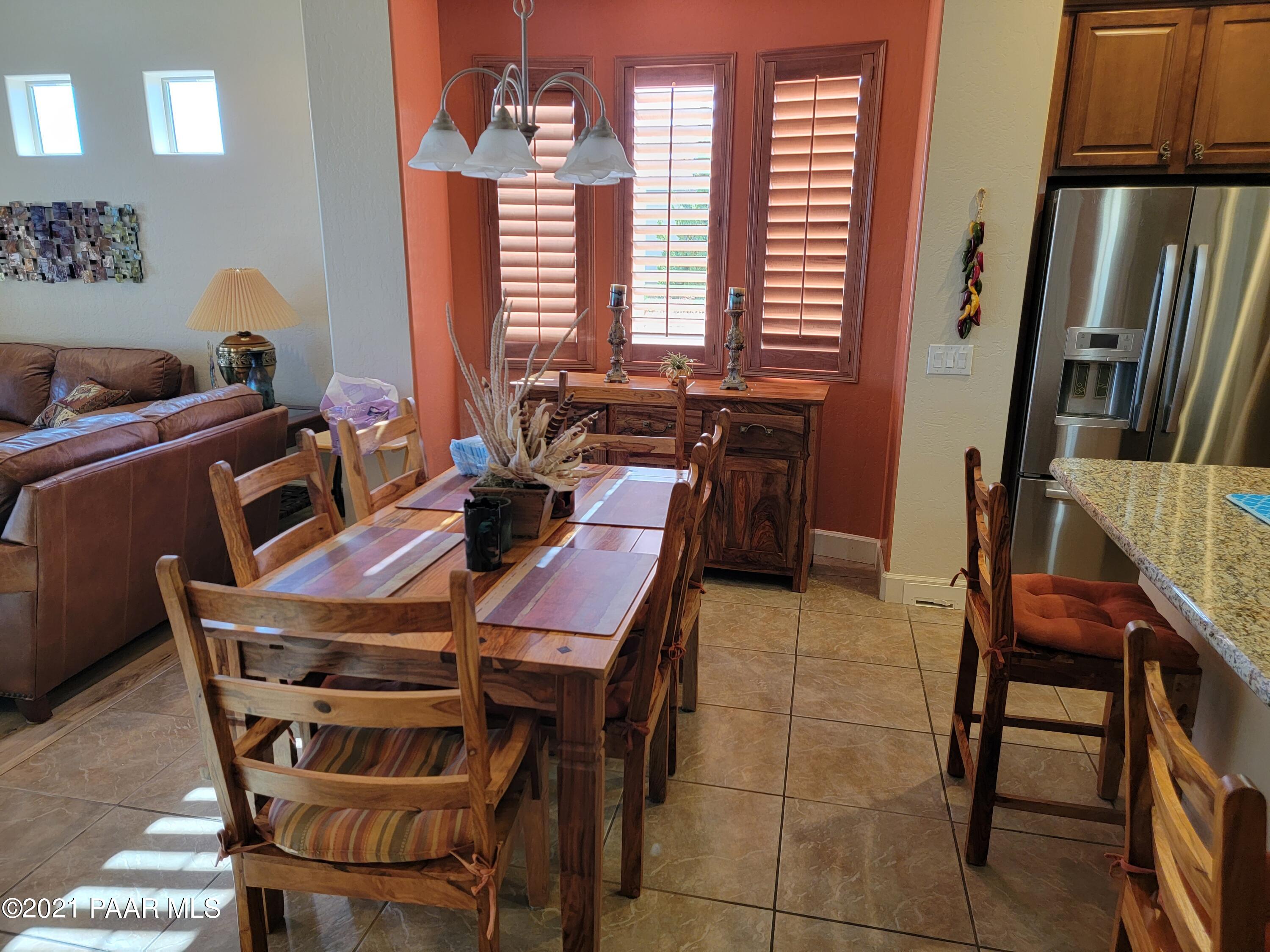 1181 Stack Rock Road Prescott Valley, AZ 86314 - Photo 9 of 25 a view of a dining room with furniture and a window
