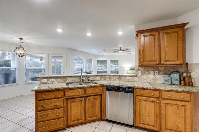 a kitchen with granite countertop kitchen island and stainless steel appliances