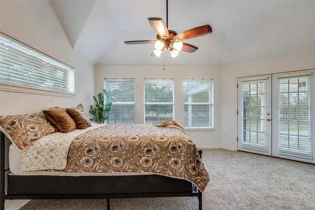 a bedroom with a large bed and a large window