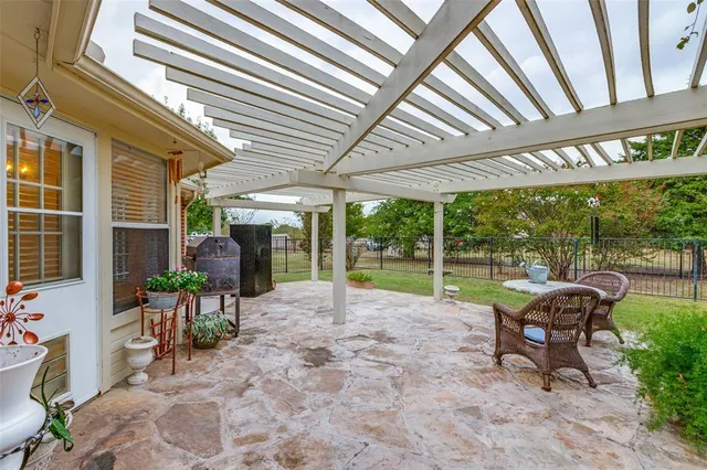 a view of a house with backyard porch and sitting area