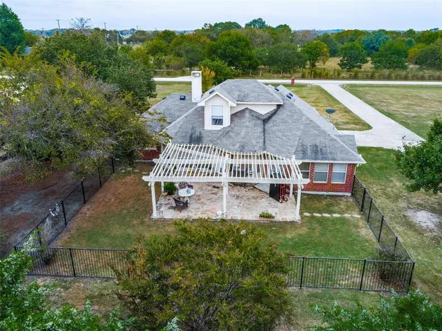a aerial view of a house with a yard