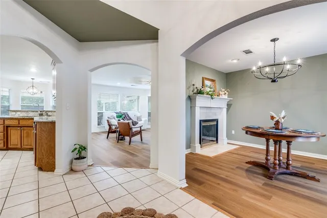 a living room with furniture a fireplace and kitchen view