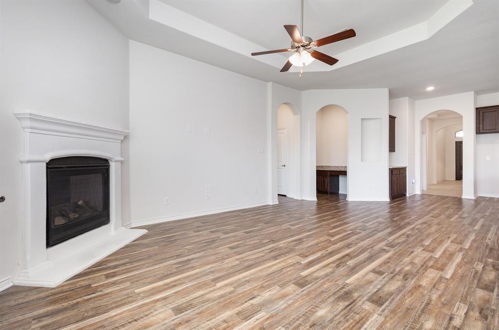 516 Maverick Street Anna, TX 75409 - Photo 13 of 28 a view of empty room with cabinet and a fireplace