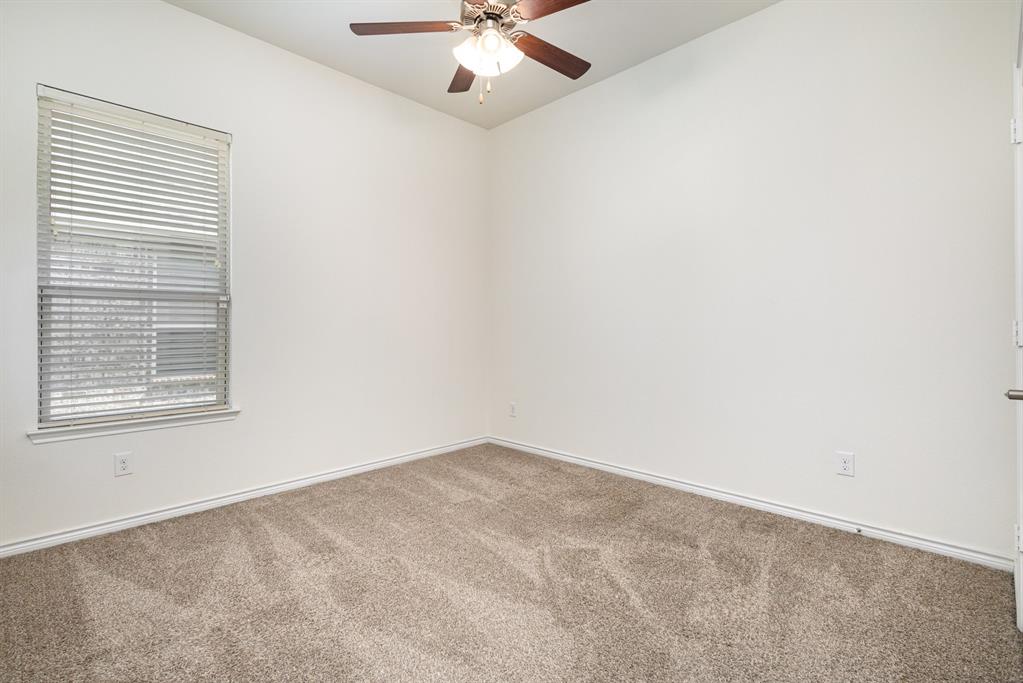 516 Maverick Street Anna, TX 75409 - Photo 17 of 28 an empty room with a window and a fan