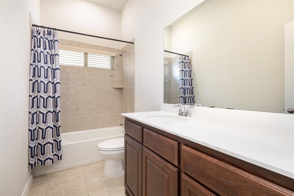 516 Maverick Street Anna, TX 75409 - Photo 23 of 28 a bathroom with a sink a toilet and shower