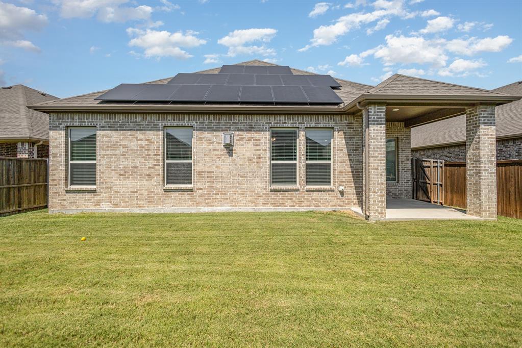 516 Maverick Street Anna, TX 75409 - Photo 26 of 28 a view of a house with floor to ceiling windows and a ceiling fan