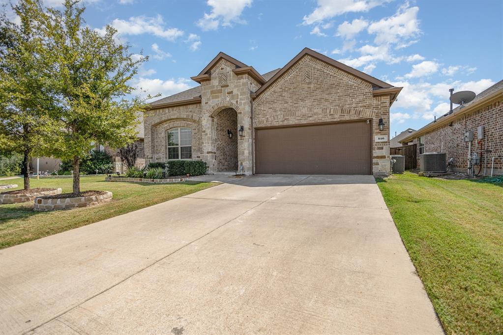 516 Maverick Street Anna, TX 75409 - Photo 3 of 28 a front view of a house with a yard and garage