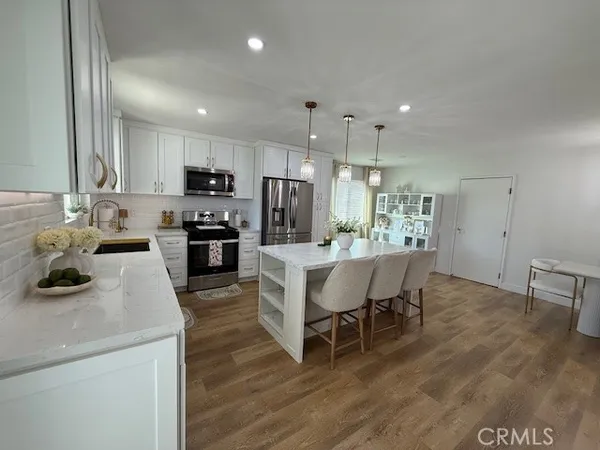 a kitchen with kitchen island granite countertop a sink and counter space