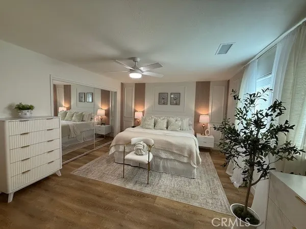 a bedroom with a bed and a potted plant