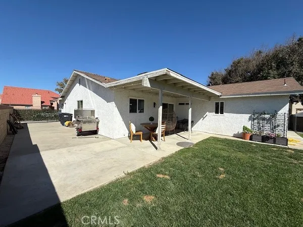 a view of a house with backyard porch and sitting area