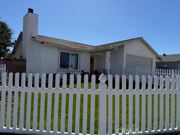 a view of a house with wooden fence