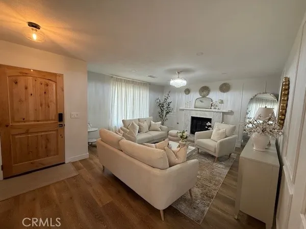 a living room with furniture a fireplace and a table