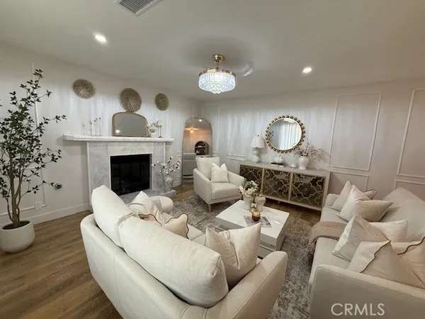a living room with furniture fireplace and a potted plant