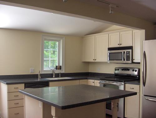 54 Under Mountain Road Lenox, MA 01240 - Photo 3 of 8 a kitchen with a sink a counter and cabinets