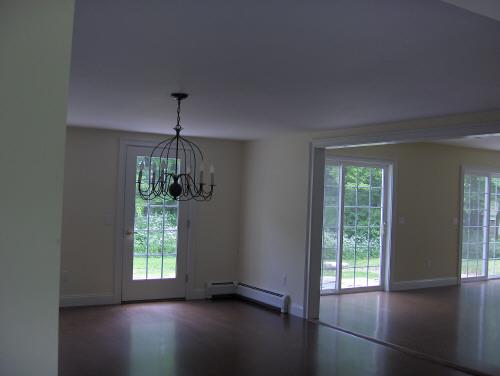 54 Under Mountain Road Lenox, MA 01240 - Photo 4 of 8 a view of an empty room with wooden floor and a window