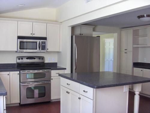 54 Under Mountain Road Lenox, MA 01240 - Photo 6 of 8 a kitchen with granite countertop a refrigerator stove and microwave