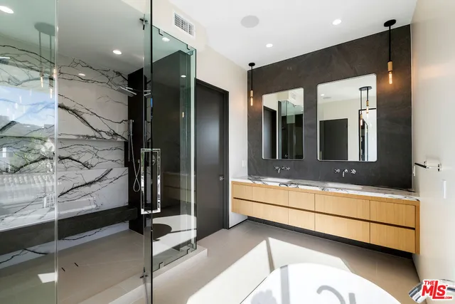 a bathroom with a double vanity sink and mirror
