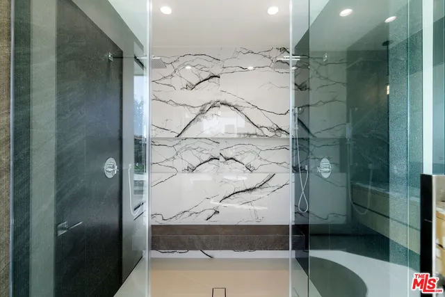 a bathroom with a tub and shower