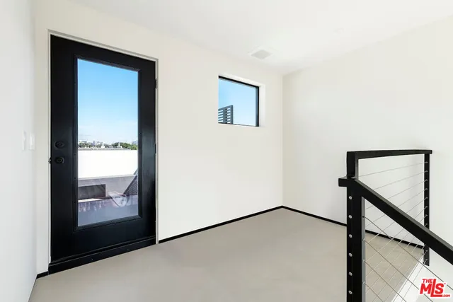 a view of an empty room with windows