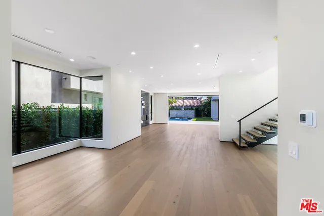 a view of an entryway with wooden floor
