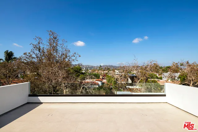 a view of a yard with an outdoor and a bench